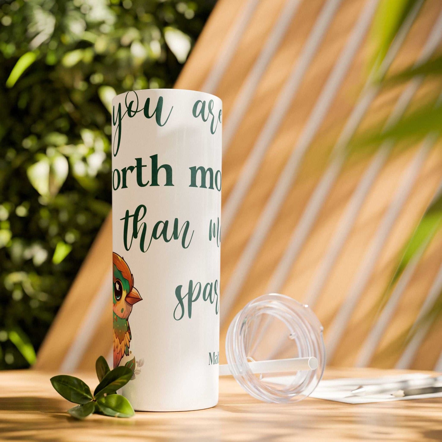 Stainless steel tumbler with "Worth More Than Sparrows" design, featuring a bird illustration, 20oz capacity, includes lid and straw.