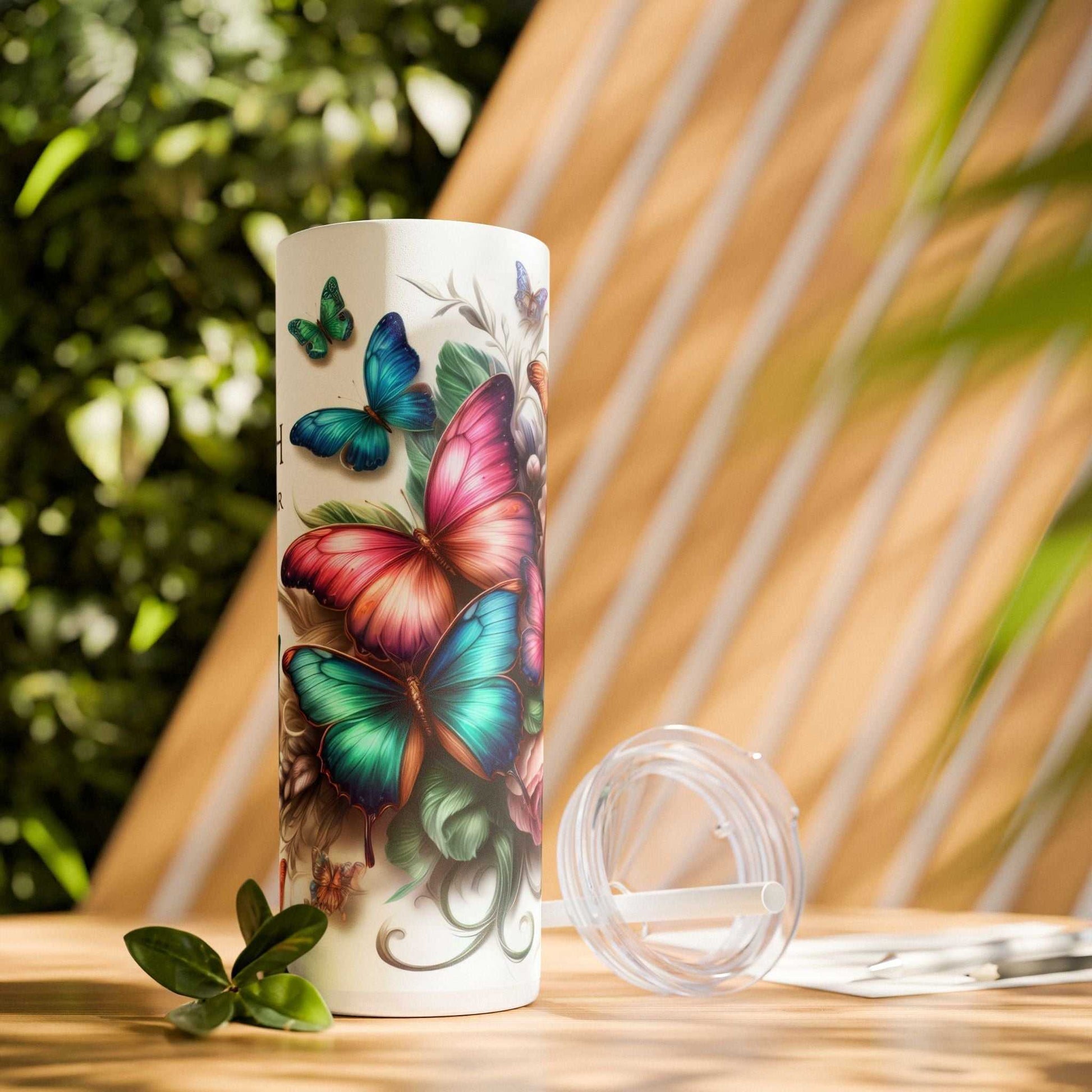 20oz tumbler with butterfly design and "Faith Conquers Fear" slogan, BPA-free, hot and cold drink insulation, matte finish.