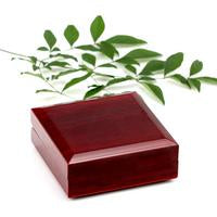 Necklace in mahogany luxury box with greenery, LED spotlight.