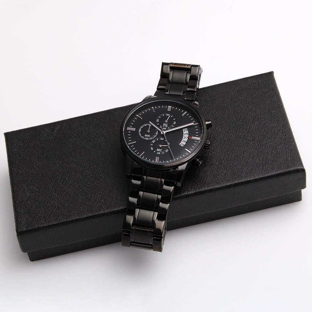 Man's engraved black chronograph watch with customizable message, featuring stainless steel and copper dial, on gift box.