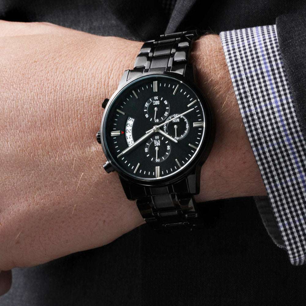 Man's engraved black chronograph watch with customizable message, stainless steel, and three-dial face.