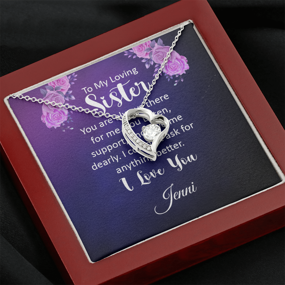 Necklace with heart-shaped pendant and message card for sister, featuring cubic zirconia crystal, displayed in a red gift box.