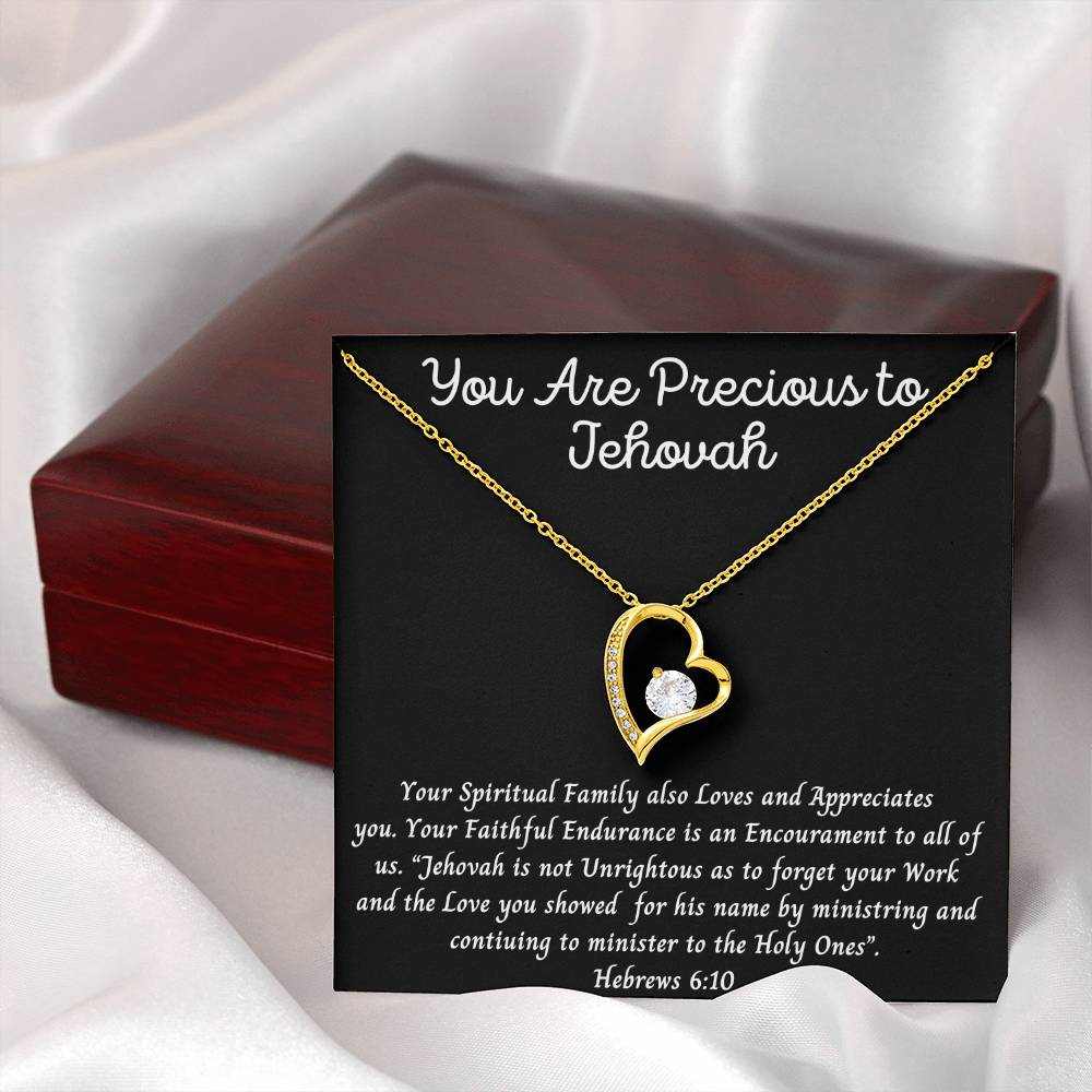 Heart-shaped necklace with "You Are Precious" inscription, featuring central cubic zirconia and smaller crystals, in white or yellow gold finish.