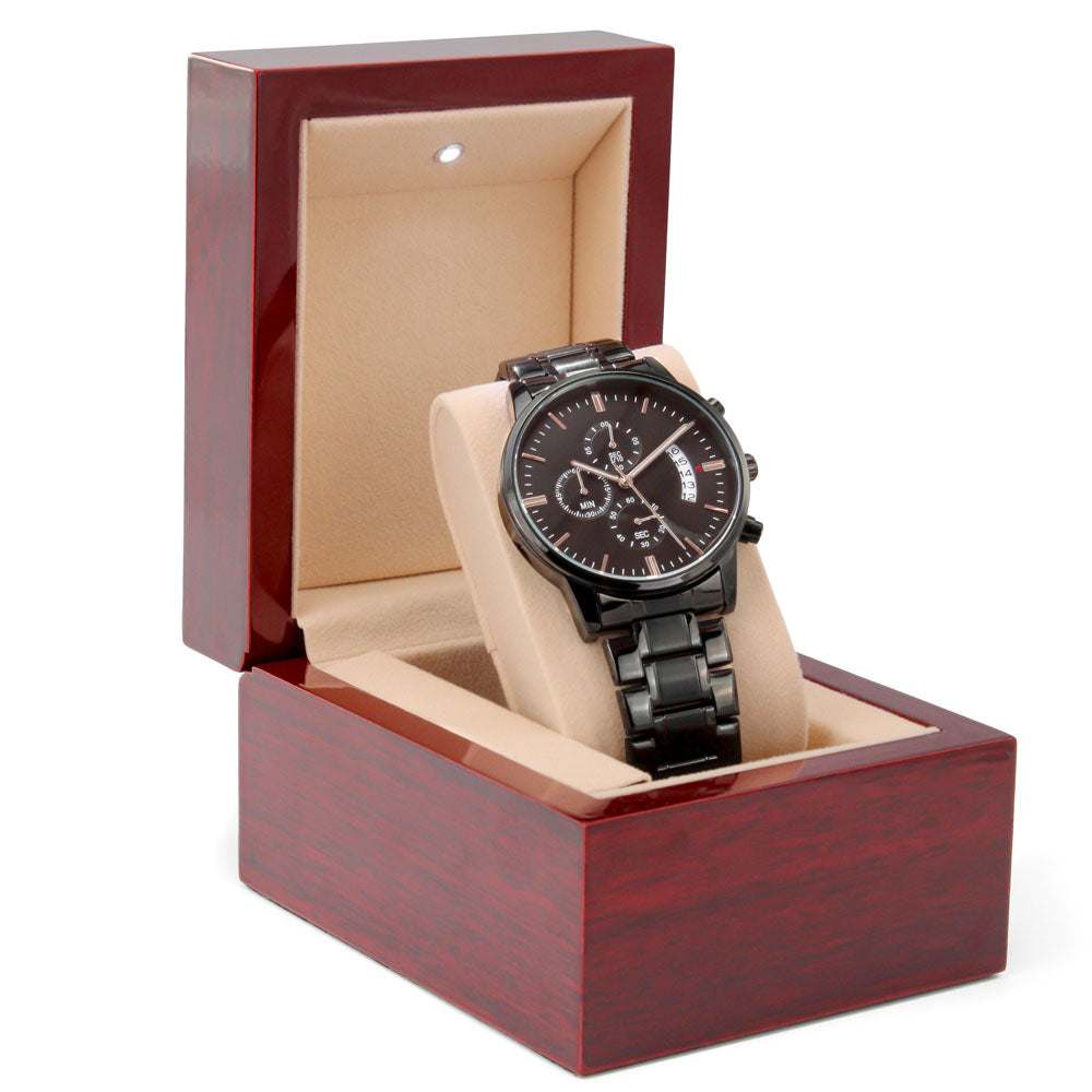 Men's black chronograph watch with engravable back, presented in a luxurious gift box.