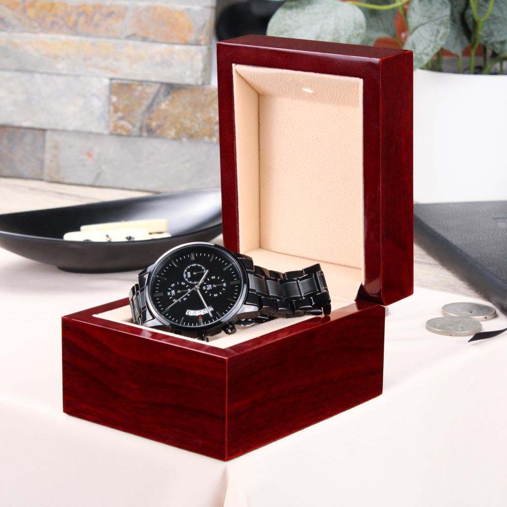 Engraved men's black chronograph watch in a wooden gift box.