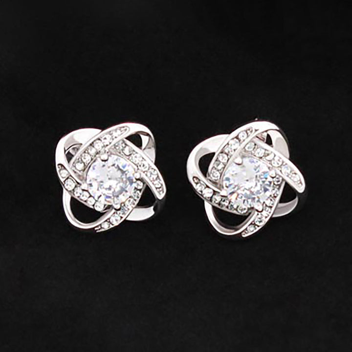 14K white gold love knot stud earrings with CZ center.