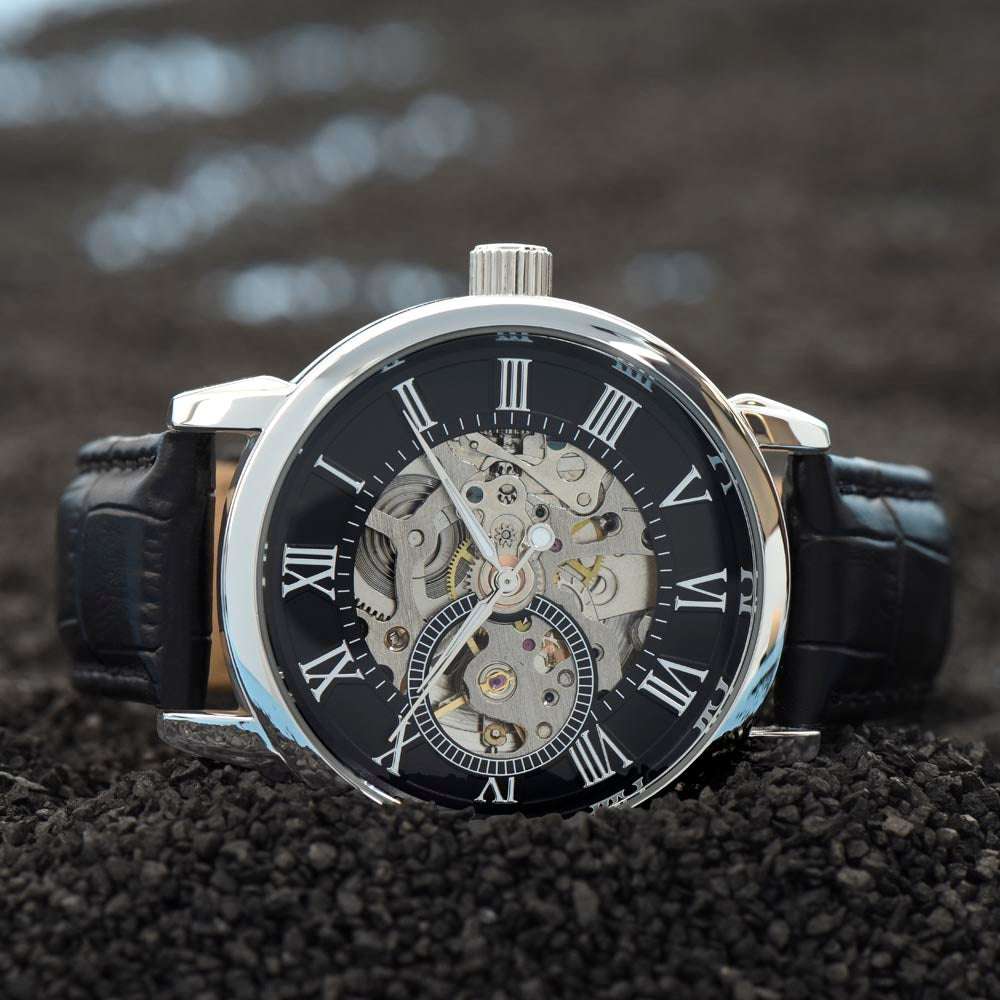 Men's open skeleton dial watch with black leather strap, automatic movement, and mineral glass.