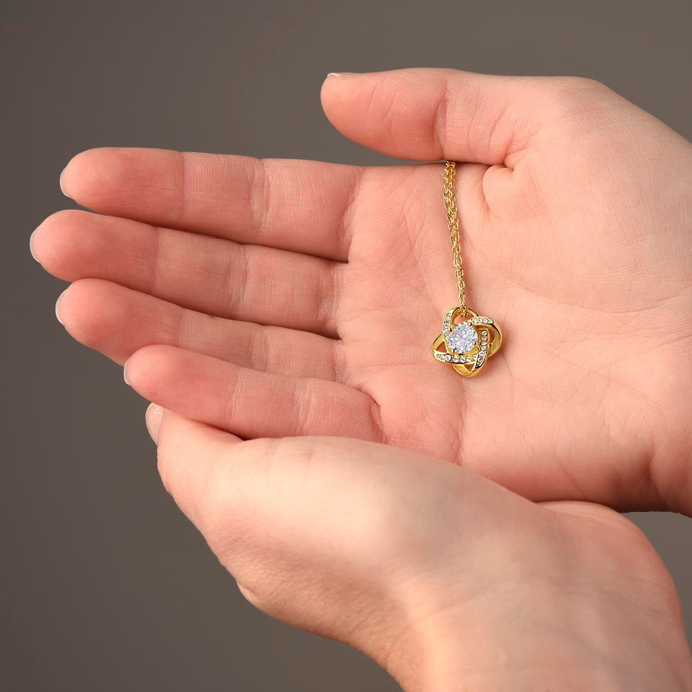 Love Knot Necklace with cubic zirconia on a hand, perfect gift for grandmother.