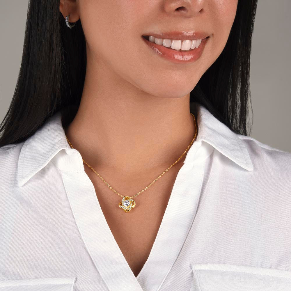 Love Knot Necklace on woman with cubic zirconia pendant, 18k gold over stainless steel, perfect gift for grandmother.