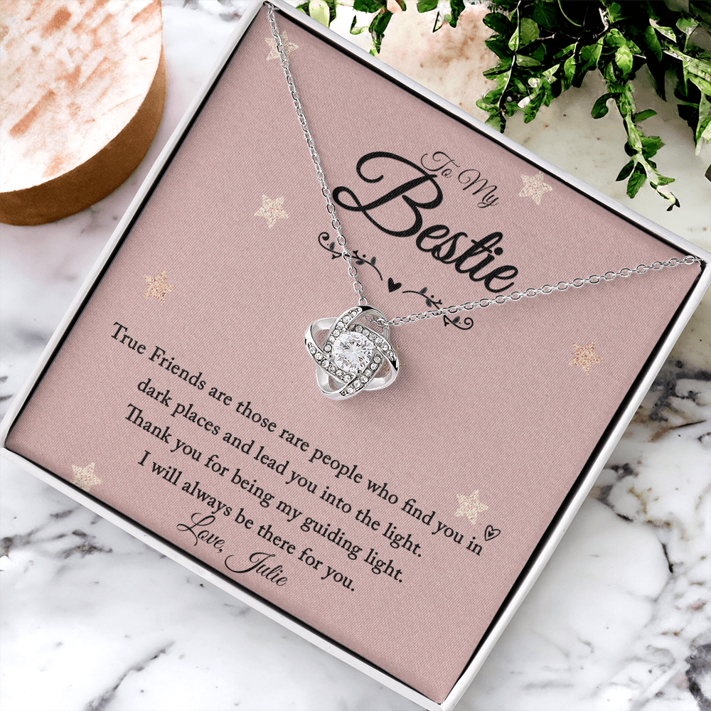 Love Knot necklace with personalized message card for friend on a decorative background.