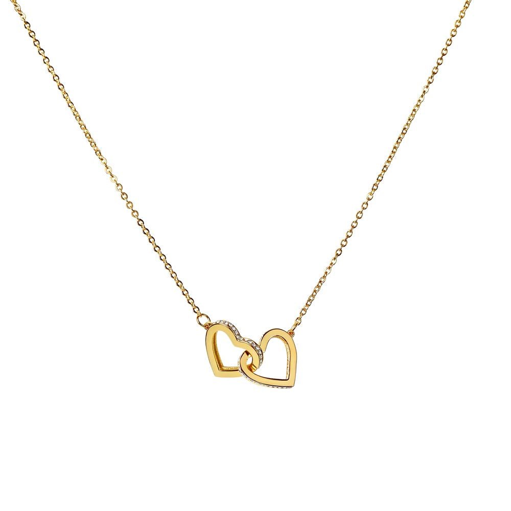 Interlocking hearts necklace with cubic zirconia on gold chain.