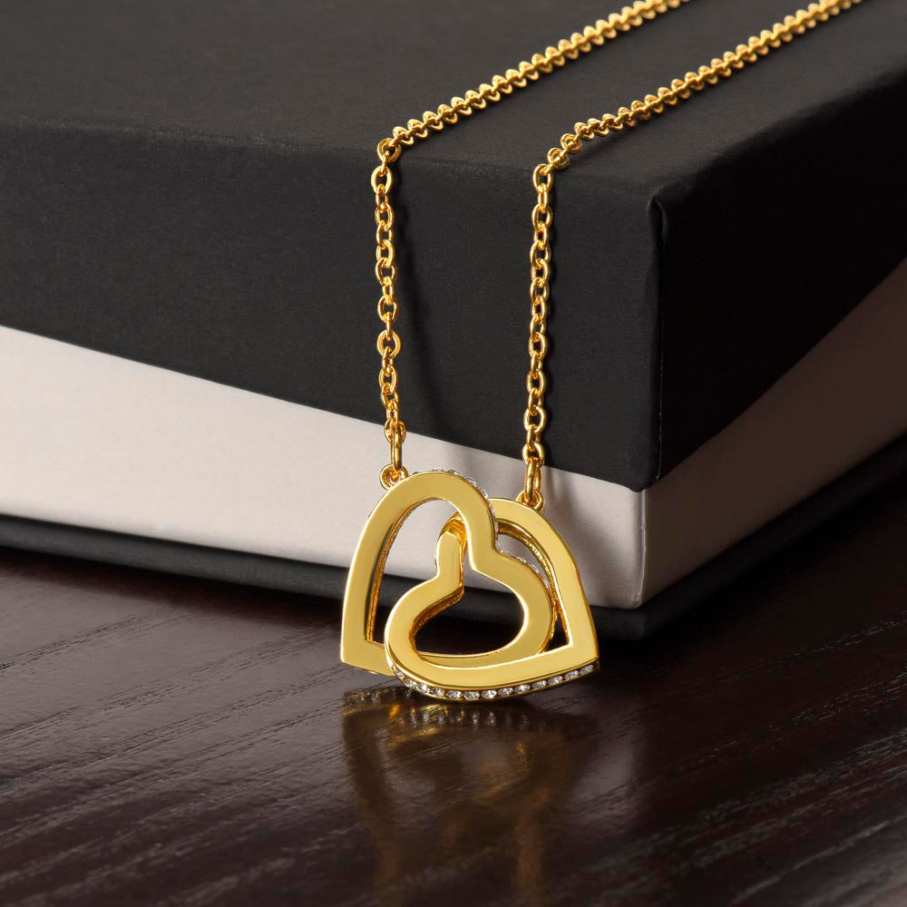 Interlocking hearts necklace with cubic zirconia, rose gold finish, on gift box.