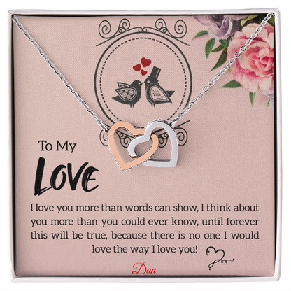 Interlocking hearts necklace with personalized message card and cubic zirconia accents.