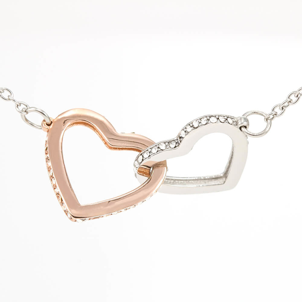 Interlocking hearts necklace in rose gold and silver with cubic zirconia accents.