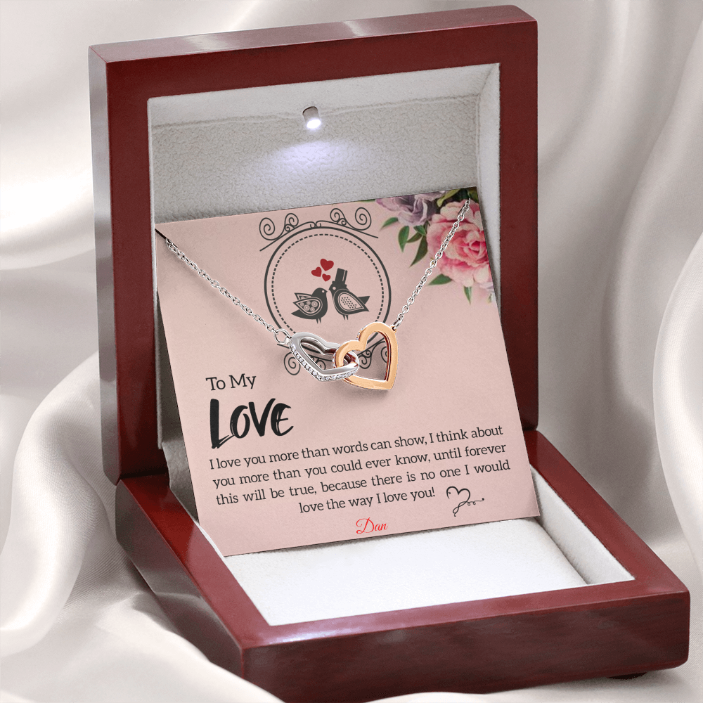 Interlocking hearts necklace with personalized message card in luxury box.