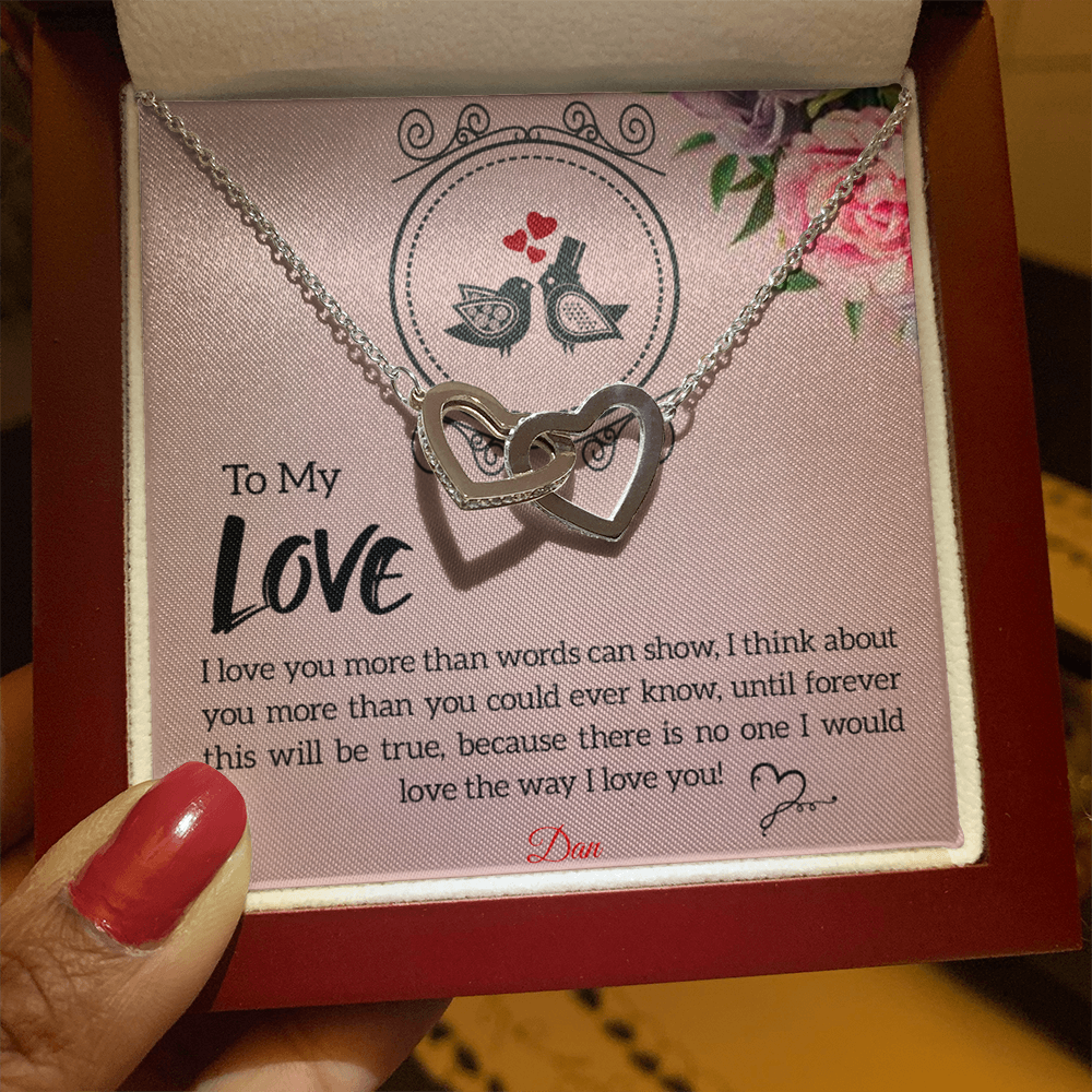 Interlocking hearts necklace with personalized message card, featuring cubic zirconia gems.