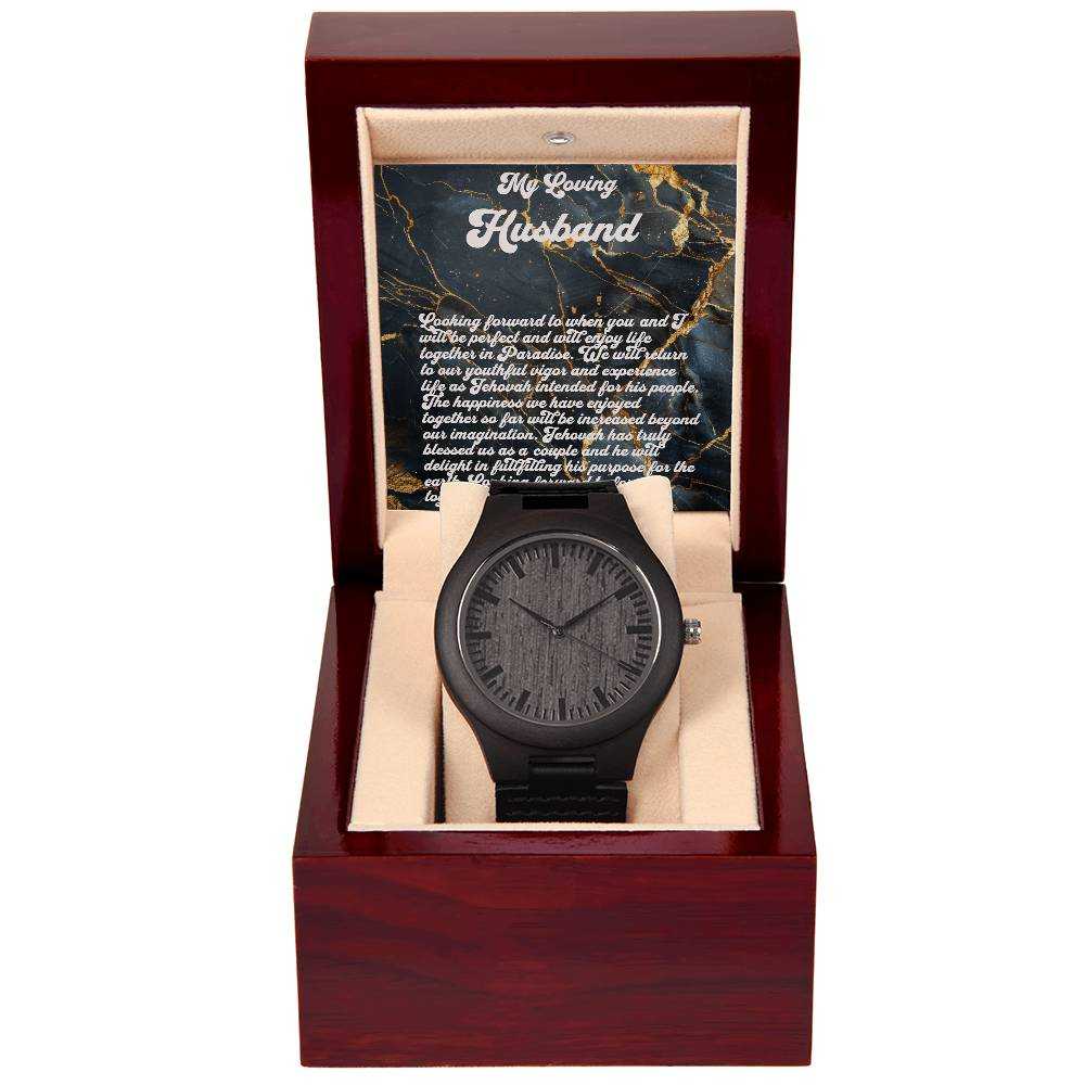 Man's wooden watch with sandalwood casing and leather strap in gift box.