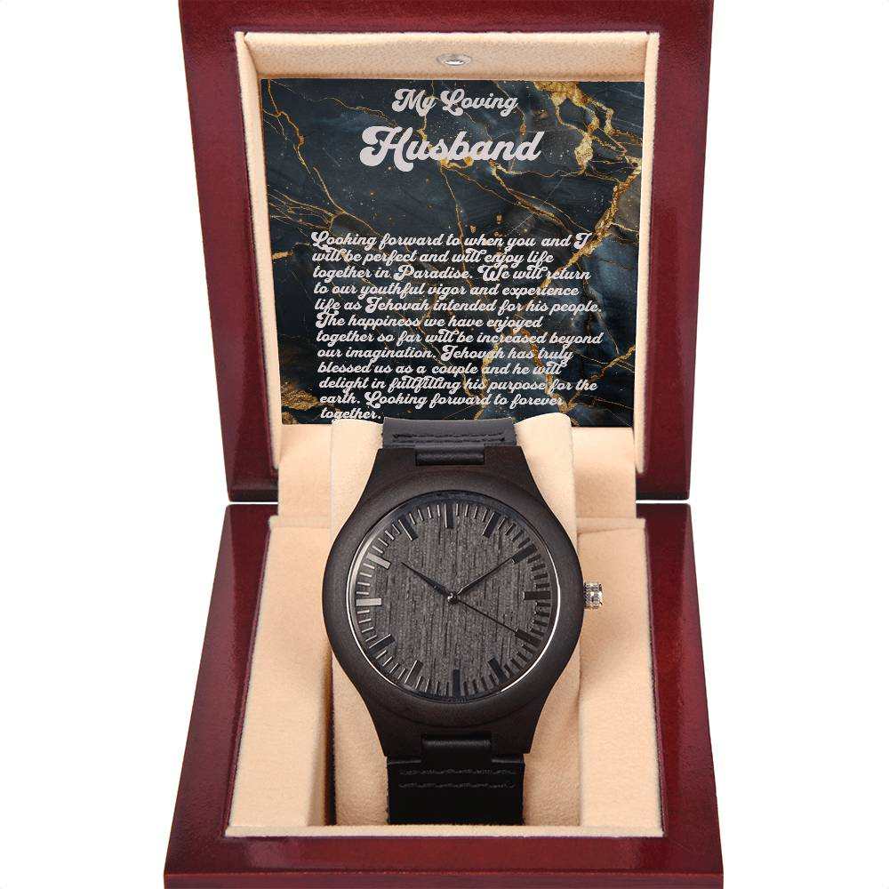 Man's wooden watch with sandalwood casing and black leather band displayed in a gift box.