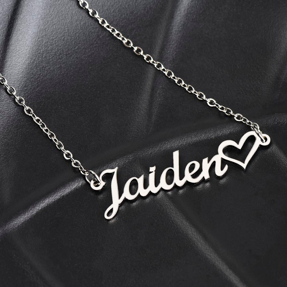 Customized name heart pendant necklace on black background.