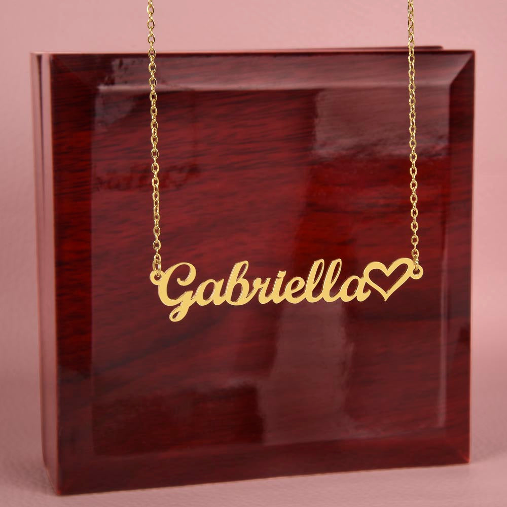 Customizable "Precious Daughter" necklace with a cursive name design and heart symbol in polished gold, displayed on a mahogany style box.