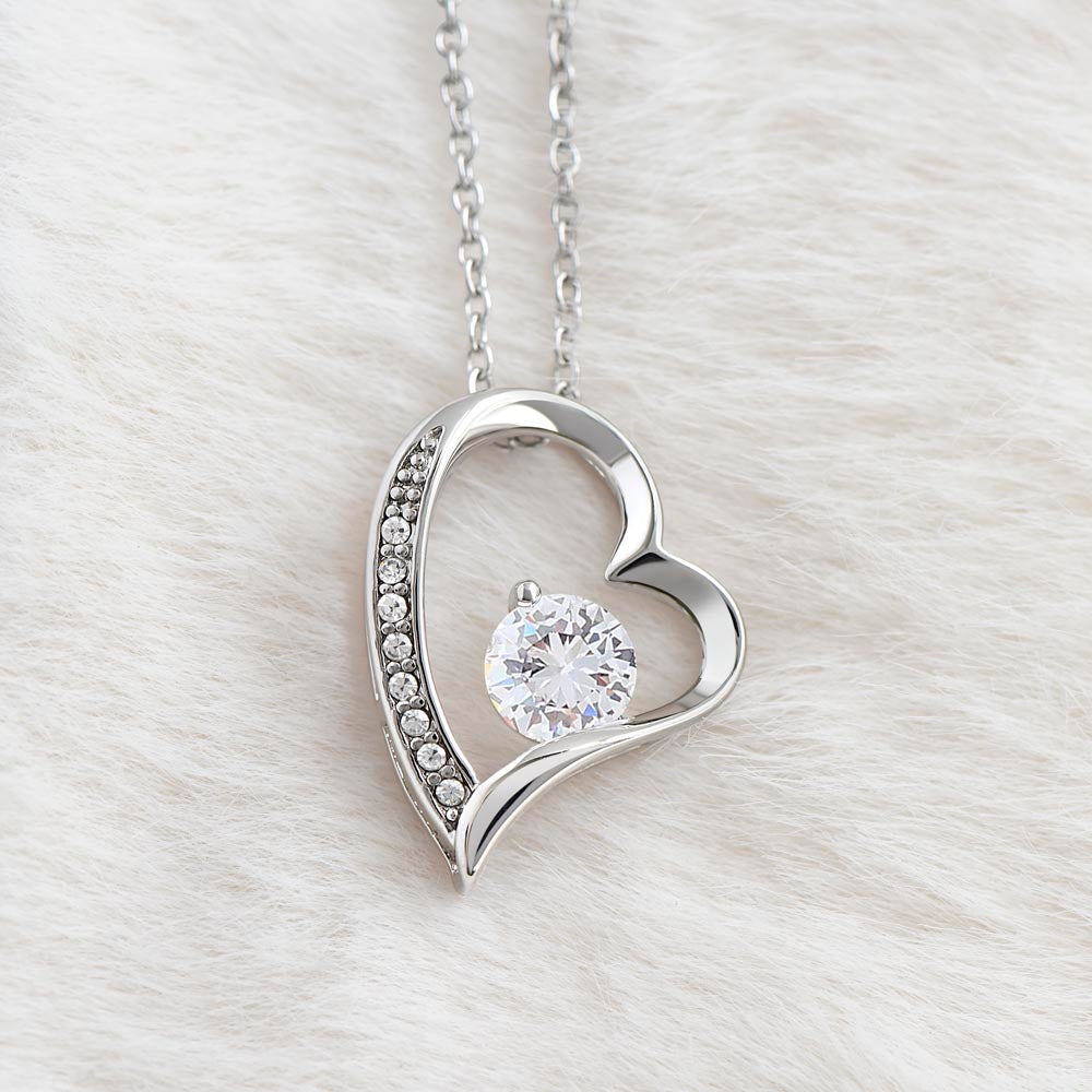 Heart-shaped necklace with CZ crystal and white gold finish.