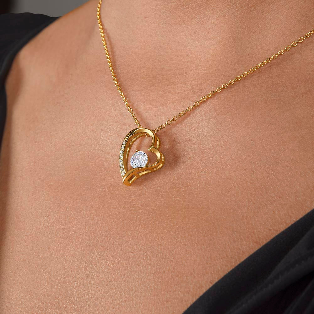 Gold heart pendant necklace with cubic zirconia.