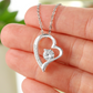 Heart-shaped necklace with cubic zirconia stone and white gold finish.